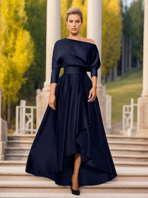 A woman wearing a navy, one-shoulder, 3/4 sleeve, asymmetrical hemline satin dress suitable for mother of the bride or groom.